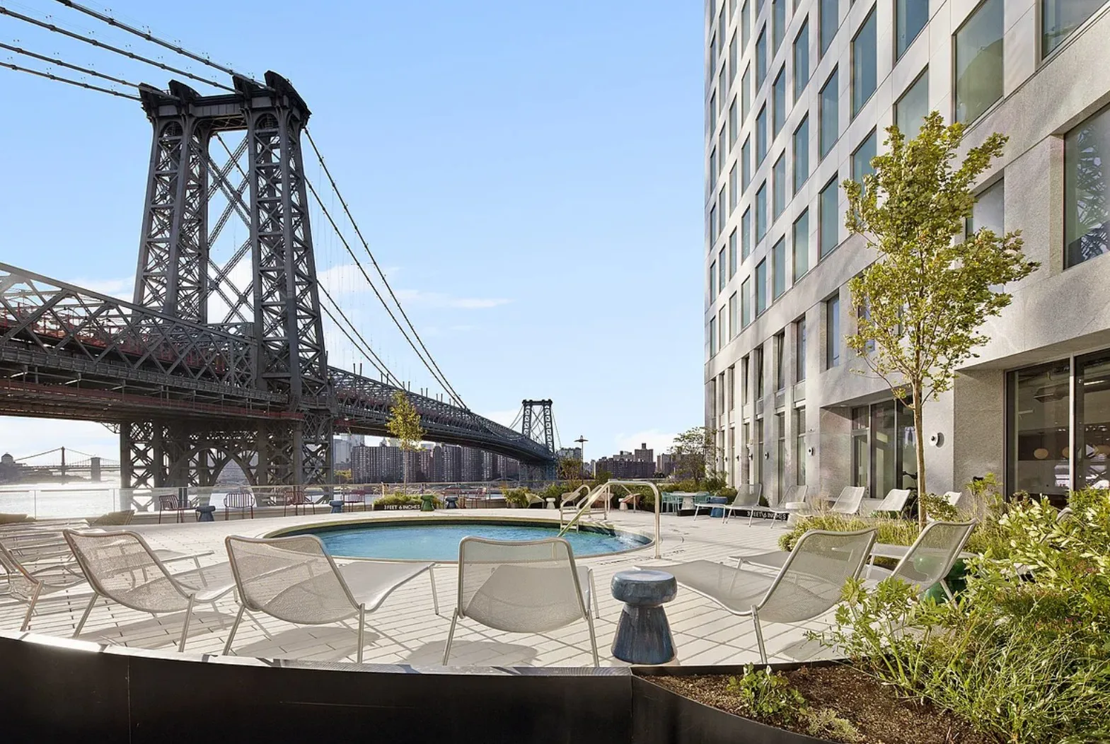 Residential tower pool terrace overlooking the Williamsburg Bridge and East River.