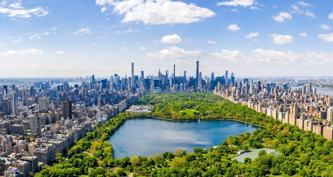 Aerial panorama of Manhattan and Central Park, with the Reservoir in the foreground.