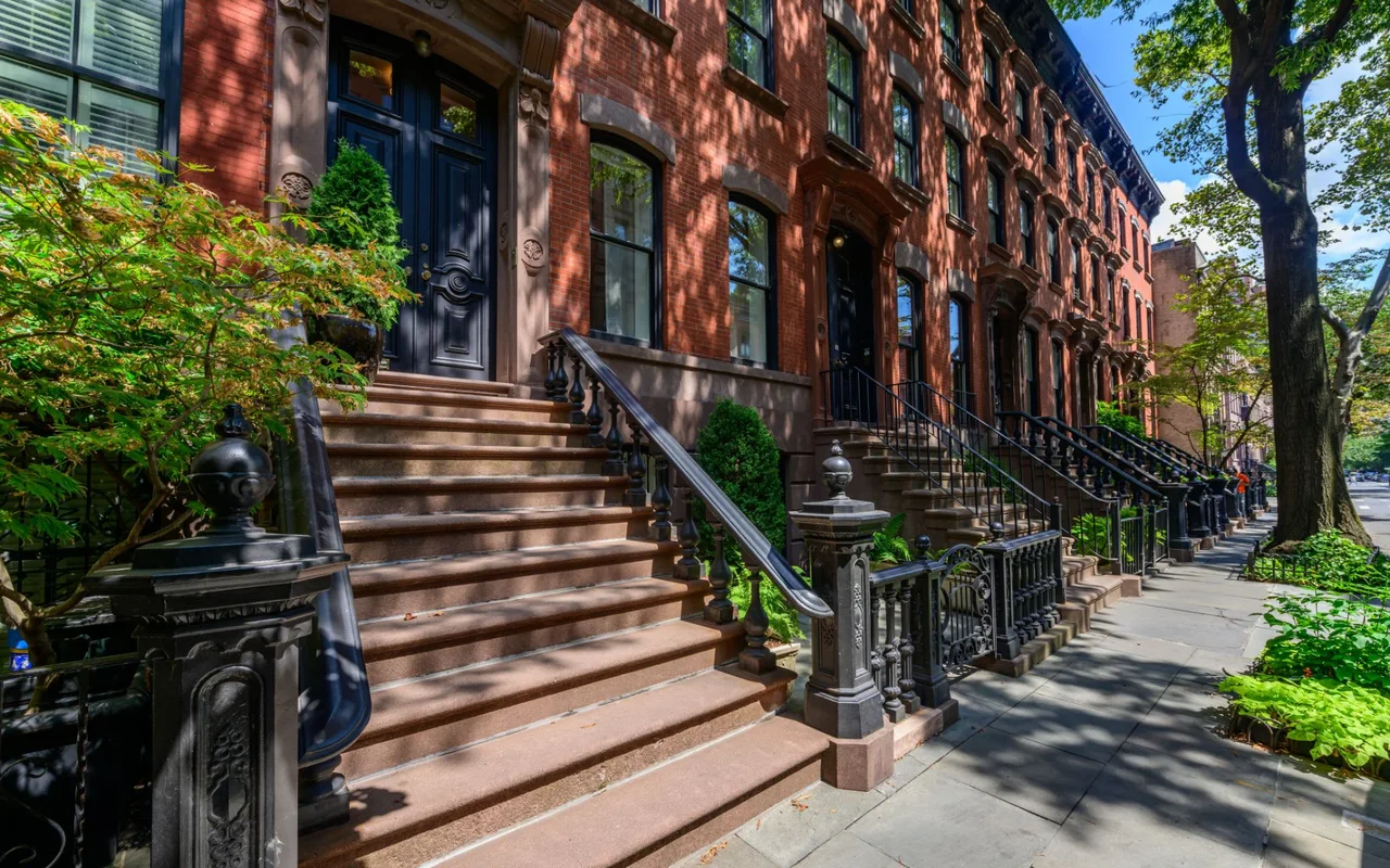 Brownstone stoops on a tree-lined street in the West Village, Manhattan